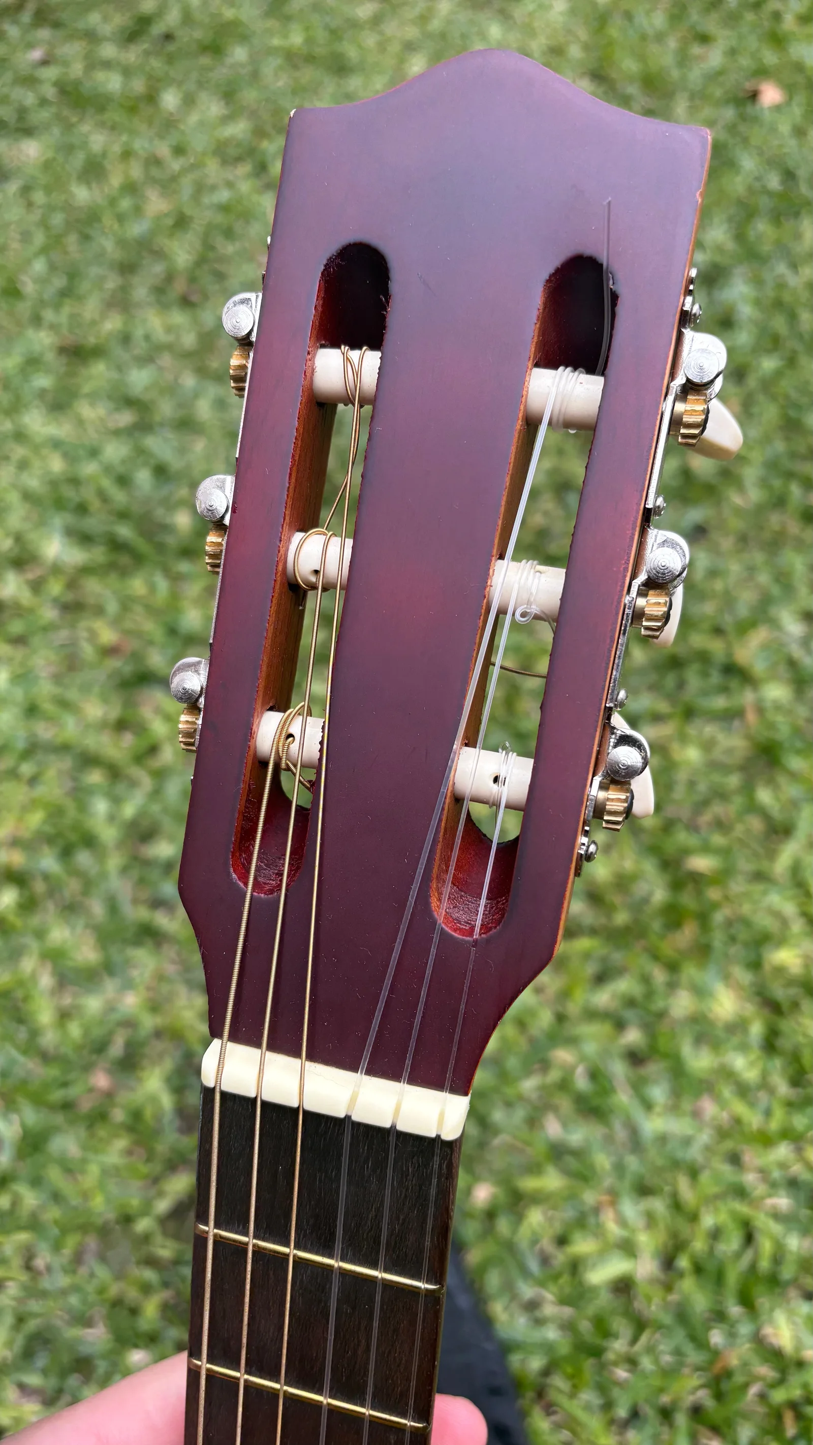 Parte frontal del clavijero, cuerdas y comienzo del diapasón de la guitarra